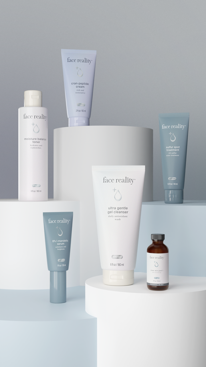 Assorted Face Reality skincare products displayed on a clean countertop, including cleansers, toners, serums, and moisturizers for acne-prone skin.