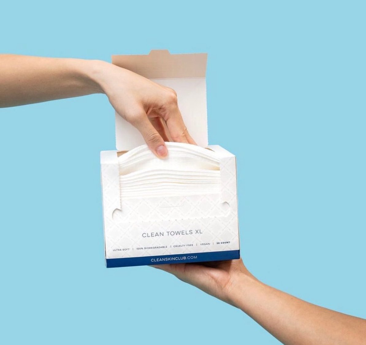 Clean Skin Club premium facial towels displayed on a clean surface, showcasing soft, single-use towels designed for a fresh and hygienic skincare routine.